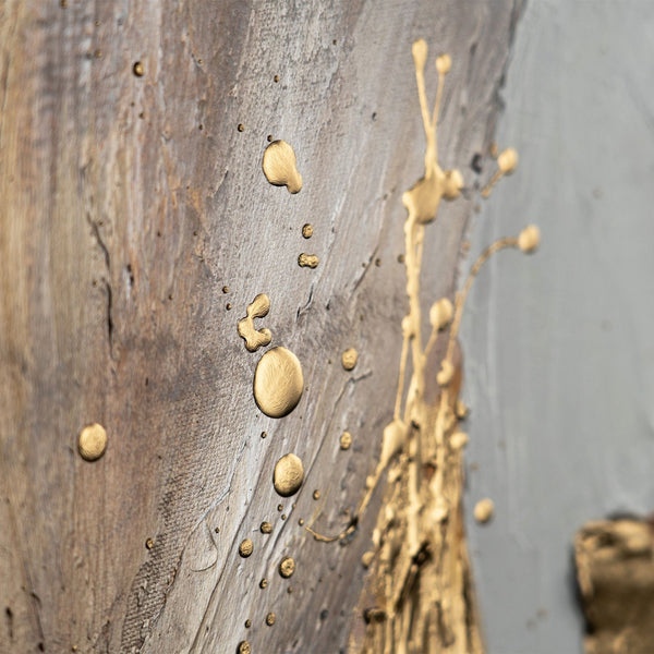 Abstract painting close-up showcasing golden droplets on a textured grey canvas, ideal for enhancing modern home decor