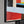 Gemälde „Architektur der Bewegung“ leuchtende geometrische Abstraktion in Rot- und Schwarztönen.